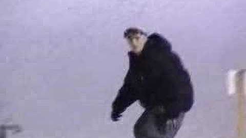 Snowboarding frontside boardslide on rail