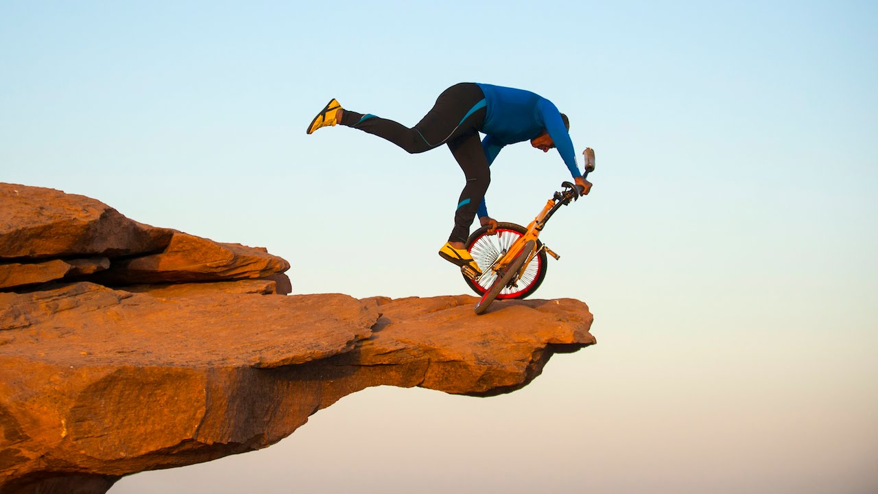 Clifftop BMX Yoga: Extreme 68-year-old Performs On Bike 300ft Above Ground