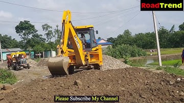 JCB Backhoe leveling Gravel in new road construction.