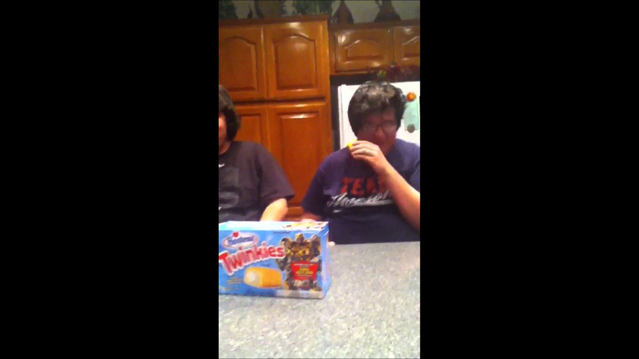 Two fat guys eating a twinkie