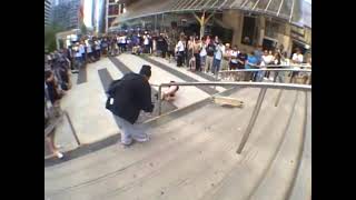 Girl rides longboard skateboard down stairs then falls forward and lands on head (Angle 5)