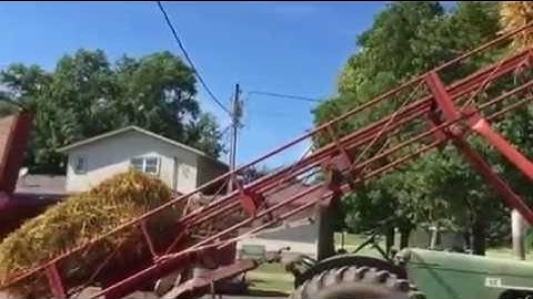 Unloading straw bales