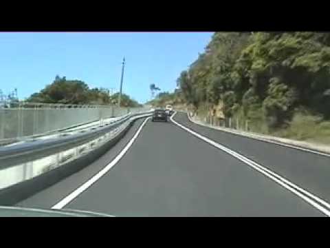 Here's a video with two sections of travelling south then north on the SEACLIFF BRIDGE on Lawrence Hargrave Drive (Grand Pacific Drive to tourists) just after it opened. The Drive was closed because it had the habit of either having boulders fall on it (and cars) or had parts of the Drive slide and drop in the ocean. Trouble is, rocks still do fall on the northern bend section but the New South Wales current State Labor Government did save $49 million dollars by only building the south section.