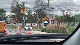 Berkeley Township Police crown Victoria assisting construction workers fixing pole that fell