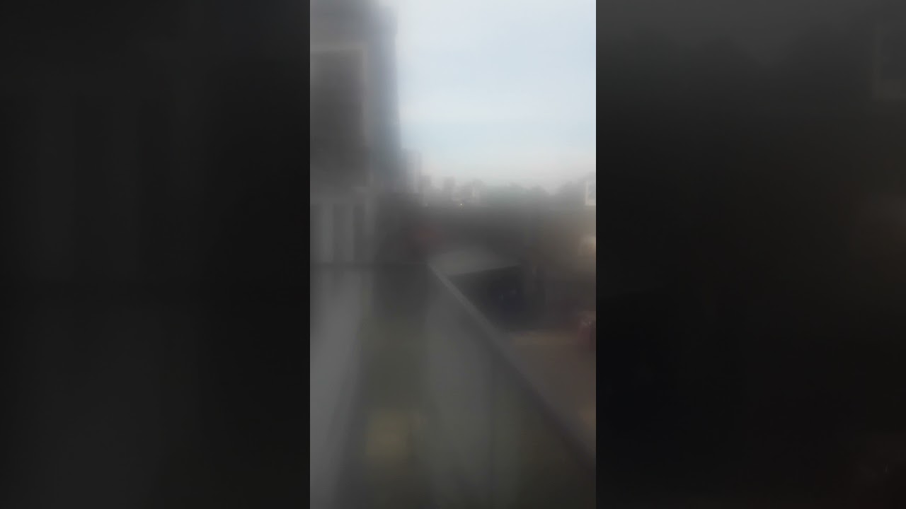 Another london overground train at my balcony with a girl on her's