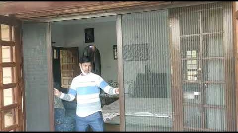 mosquito net on wooden door #sgcaravan #upvcwindowsanddoors #upvcwindowdealer