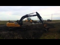 An excavator removing an old bridge.