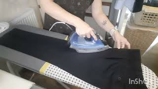 Ironing trousers with creases.
