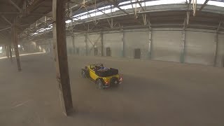 CHALLENGE: Flying indoors with a drone in an abandoned car factory following prewar cars.
