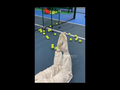 Playing tennis wearing only white socks