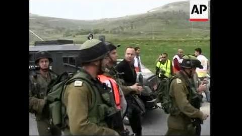 Palestinian protesters clash with Israeli troops at a West Bank checkpoint