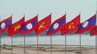 Lao and Communist flag vawing  Vientiane Riverfront 2012.