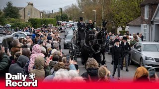 Paul O'Grady laid to rest as hundreds line streets in honour of the entertainer