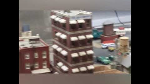 HO scale mogul moving an empty coal train around the layout