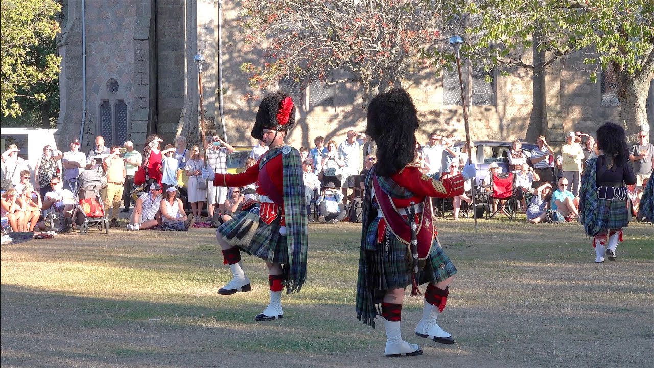 Drum Salute and march by Ballater Pipe Band on Ballater Green during