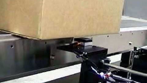 Label Printer Applicator applying labels to the bottom of a box