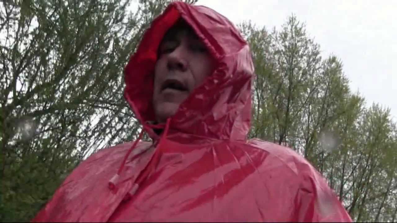 Paul Walking in the rain wearing a red pvc mac