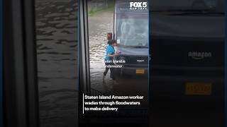 Amazon driver wades through floodwaters to deliver package