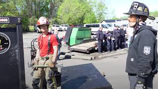 Instructor Provides Firefighter Forcible Entry Training, Showing Use of Forcible Entry Tools