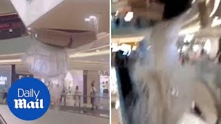 A part of ceiling collapsed in front horrified shoppers yesterday
after heavy rain leaked through the roof mall during storm central
china. ra...