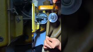Sewing a thick leather piece with an industrial sewing machine to create durable footwear products