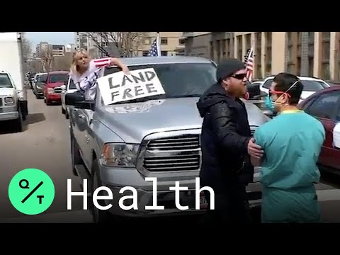 Counter-Protesters in Scrubs Block Anti-Lockdown Campaigners in Denver