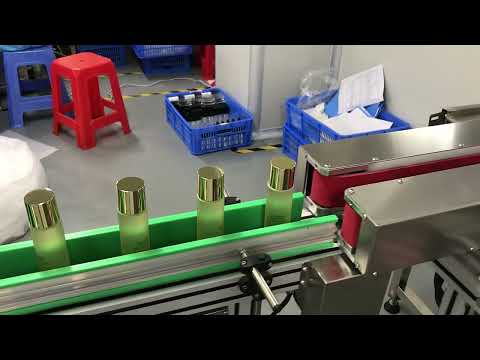 Bottle gripper conveyor for bottom coding printing