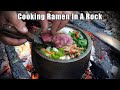 Cooking ramen in a stone bowl over a camp fire