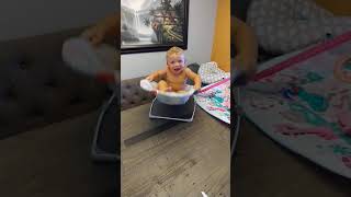 Baby boy rocks back and forth on bouncer and falls off tablet onto couch