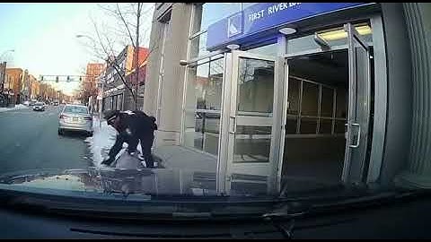The moment of arresting a thief coming out of a bank
