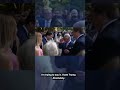 King Charles meets impersonator at garden party