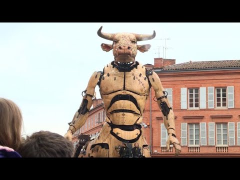 A minotaur and giant spider parade through Toulouse streets