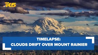 Clouds drift over Mount Rainier at sunset