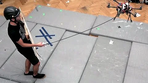 Human-State-Aware Controller for a Tethered Aerial Robot Guiding a Human by Physical Interaction