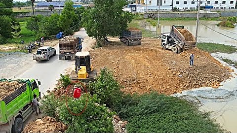 New project!! Bulldozer pushing dirt soil into water with dump truck unloading soil