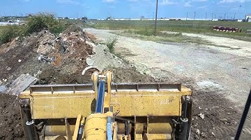 Justin using front end loader at his job