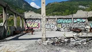 Abandoned and burned down car repair shop with Citroen DS and Jaguar E-Type