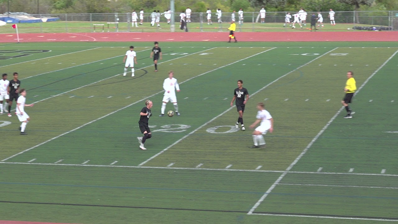 High School Soccer Referee Recognizing Unsporting Foul and Serving
