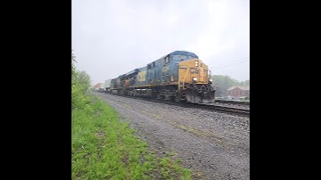 CSX Train I020 with old Gevo locomotive with a new nose door rolls flies through the rain!
