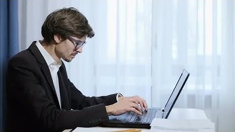 Male Employee Typing On Laptop Stock Video