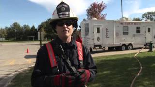 Robins firefighters use mobile house to teach elementary students fire safety