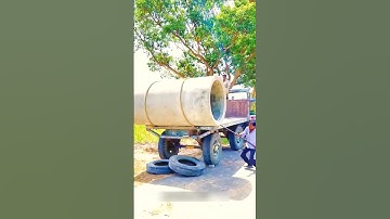 The process of manually unloading a concrete pipe from a truck