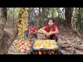 Yummy! Chicken egg grilled on the rock and Natural sour fruit for food in forest - Survival cooking