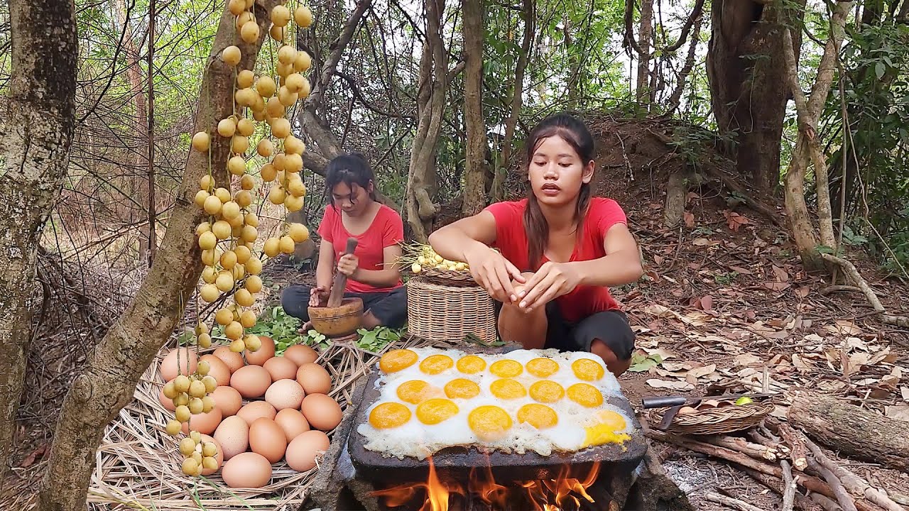 Yummy! Chicken egg grilled on the rock and Natural sour fruit for food ...