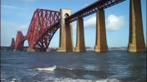 Spring Train Crossing Forth Railway Bridge On History Visit To South Queensferry Scotland