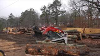 Skid Steer Moving Logs