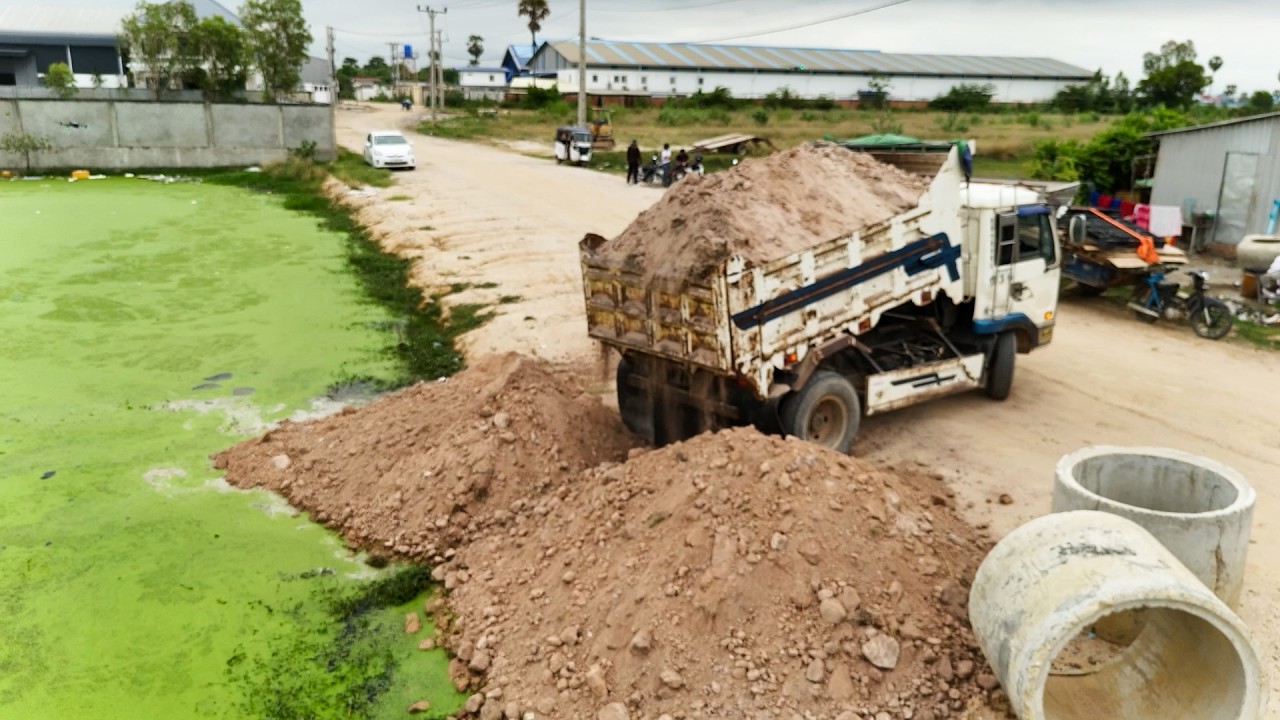 Great Landfill Task Using Bulldozer Push Soil With Trucks Dumping Into Flood Land Area