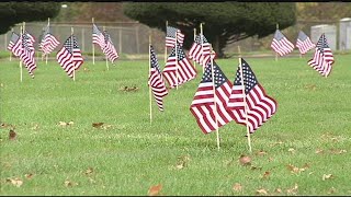 Veterans and volunteers gathered to place flags at veteran's graveside