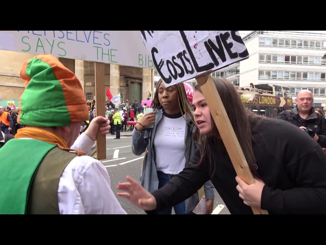 'Racist' leprechaun priest shouted down by protesters class=