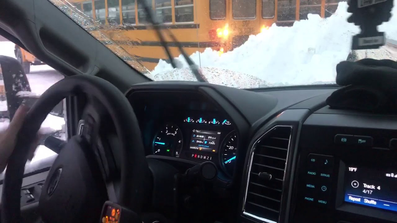Snow removal underway at the bus lot - YouTube
